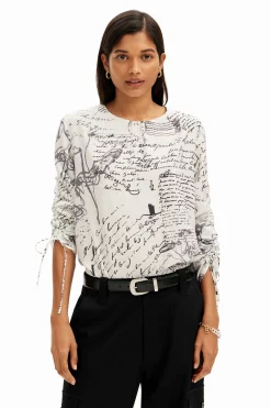 Blouse with adjustable sleeves and text prints.